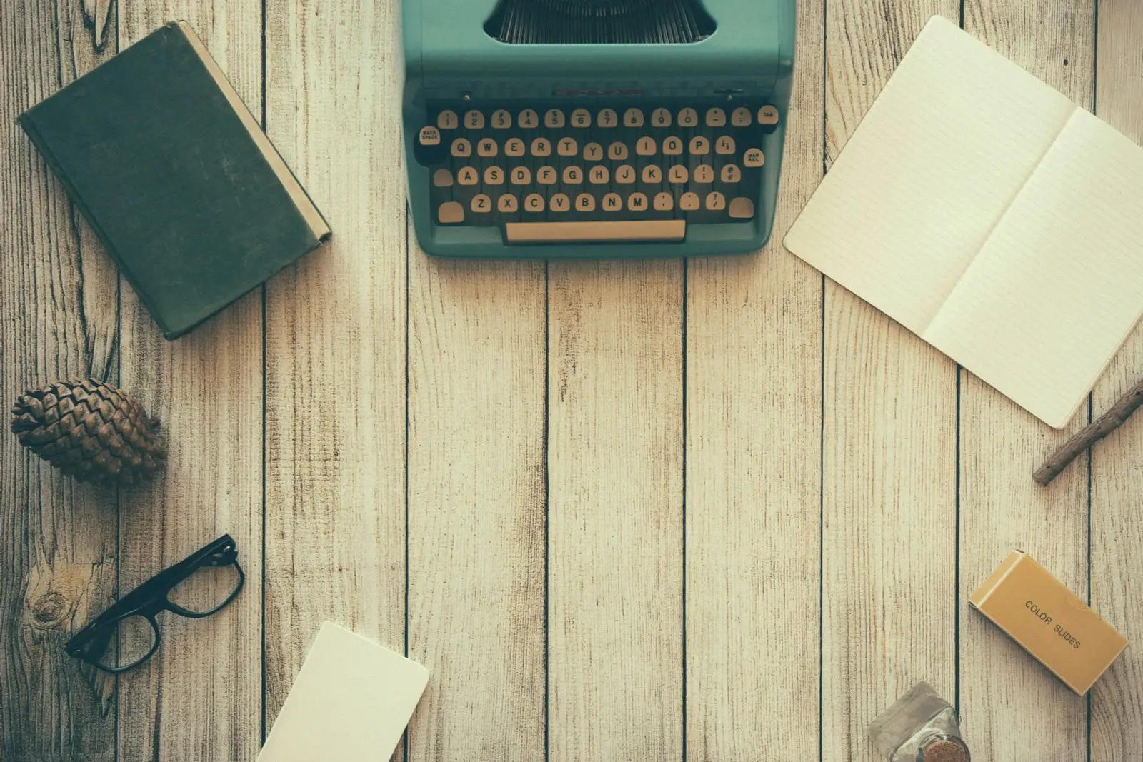 Notebook and laptop on a wooden desk